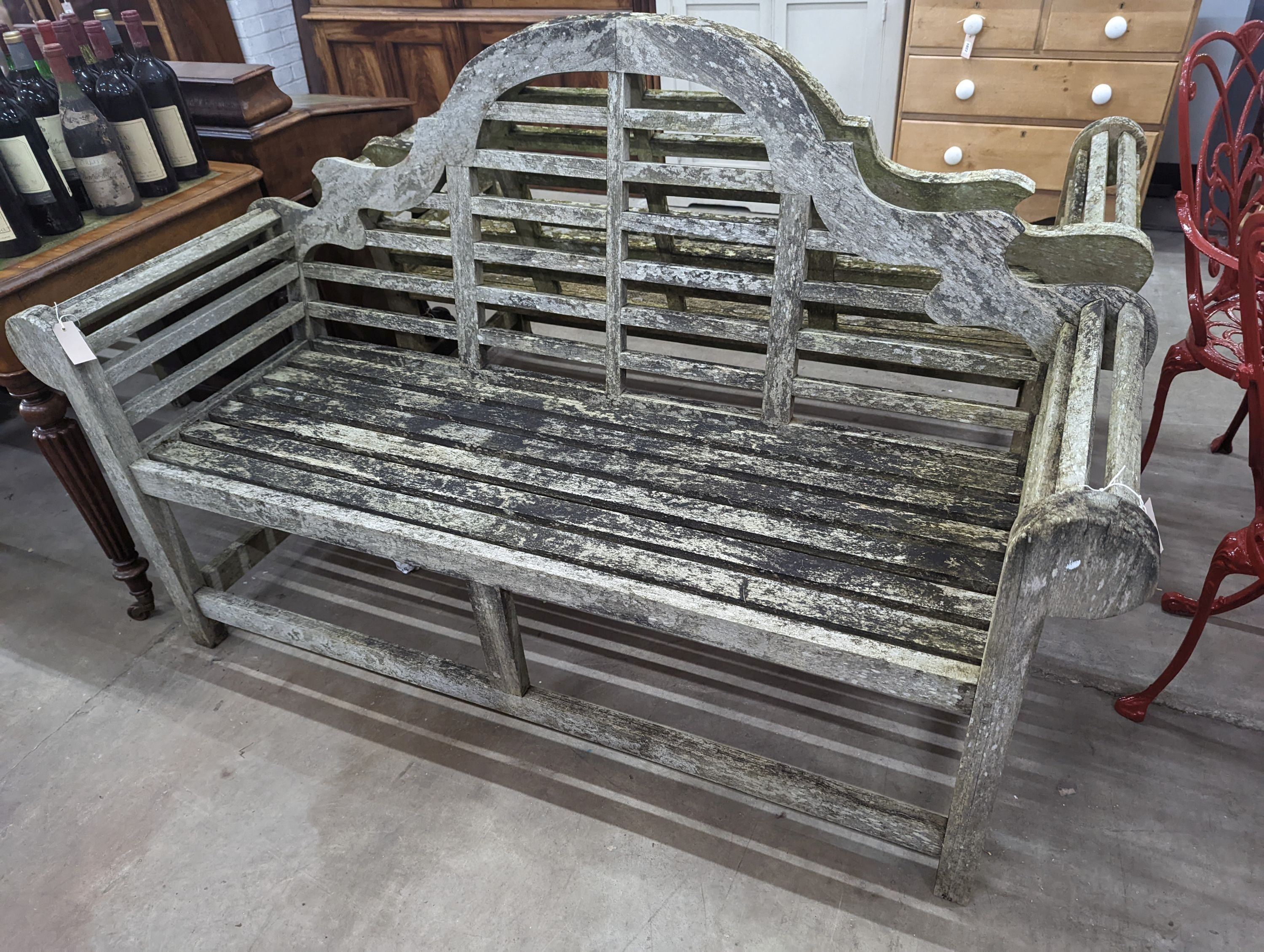 A pair of Lutyens design weathered teak garden benches, length 167cm, depth 58cm, height 104cm